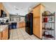 Well-lit kitchen with stainless steel appliances, wooden cabinetry, and tile floors at 16469 W Century Plant Dr, Surprise, AZ 85387