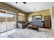 Spacious living room with tile floors, sliding glass doors, and comfortable seating at 16469 W Century Plant Dr, Surprise, AZ 85387