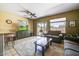Bright living room features sliding glass door, tile flooring, and comfortable seating at 16469 W Century Plant Dr, Surprise, AZ 85387