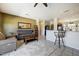 Cozy living room adjacent to kitchen with gray sofa, wood coffee table, and bar seating at 16469 W Century Plant Dr, Surprise, AZ 85387