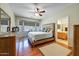 Inviting main bedroom with hardwood floors, bay window, and ensuite bathroom access at 16469 W Century Plant Dr, Surprise, AZ 85387