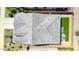 Drone shot of a gray roof with a well-maintained backyard, artificial grass and paver patio at 16528 W Pedro Ln, Goodyear, AZ 85338