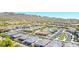 An aerial view of a desert neighborhood with mountains in the background, showcasing the community layout and surroundings at 16528 W Pedro Ln, Goodyear, AZ 85338