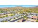 Aerial view of a community with homes, desert landscaping, and a mountain backdrop, highlighting the neighborhood's setting at 16528 W Pedro Ln, Goodyear, AZ 85338