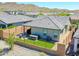 Cozy backyard with artificial grass, hot tub, brick fence, and outdoor seating area perfect for relaxation at 16528 W Pedro Ln, Goodyear, AZ 85338
