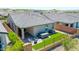 Aerial view of the backyard with a hot tub, fire pit, artificial grass, and a covered patio at 16528 W Pedro Ln, Goodyear, AZ 85338