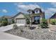 Inviting home exterior with a well-maintained yard and stone detailing enhancing the curb appeal at 16528 W Pedro Ln, Goodyear, AZ 85338