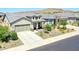 Charming single-Gathering home showcasing well-maintained landscaping, a spacious driveway, and neutral color palette at 16528 W Pedro Ln, Goodyear, AZ 85338