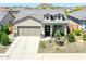 Attractive single-story home with a two-car garage, stone accents, and drought-tolerant landscaping at 16528 W Pedro Ln, Goodyear, AZ 85338