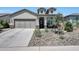 Inviting home exterior with a well-maintained yard and stone detailing enhancing the curb appeal at 16528 W Pedro Ln, Goodyear, AZ 85338