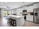 Bright modern kitchen features a large island with seating, stainless steel appliances, and an open layout at 16528 W Pedro Ln, Goodyear, AZ 85338