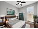 A stylish main bedroom features a statement headboard, modern dresser, and an entertainment center at 16528 W Pedro Ln, Goodyear, AZ 85338