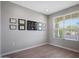 Bright office with a view features neutral paint and wood-look tile flooring at 16528 W Pedro Ln, Goodyear, AZ 85338