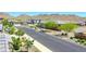 Peaceful street view showcasing well-maintained homes, desert landscaping, and mountain views at 16528 W Pedro Ln, Goodyear, AZ 85338