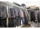 A well-organized walk-in closet with ample hanging space and storage for clothes and accessories at 16528 W Pedro Ln, Goodyear, AZ 85338