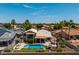 Aerial view of the backyard with a pool, patio, and a lush lawn at 18854 N 73Rd Dr, Glendale, AZ 85308