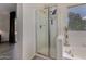 Bright bathroom features a glass shower enclosure, tub, and a neutral color palette at 18854 N 73Rd Dr, Glendale, AZ 85308