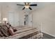 Comfortable bedroom with a ceiling fan and a view of the closet and bathroom at 18854 N 73Rd Dr, Glendale, AZ 85308