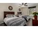 Inviting bedroom with two beds, stylish decor, and a ceiling fan at 18854 N 73Rd Dr, Glendale, AZ 85308