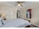 Comfortable bedroom with ceiling fan, wood floors, closet and tasteful decor create a cozy retreat at 18854 N 73Rd Dr, Glendale, AZ 85308