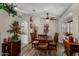 Cozy dining room featuring wood floors, a ceiling fan, and a view of the adjacent kitchen at 18854 N 73Rd Dr, Glendale, AZ 85308