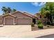 Charming two-story home showcasing a 3 car garage, desert landscaping, and tile roof at 18854 N 73Rd Dr, Glendale, AZ 85308
