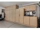 Spacious garage with ample storage cabinets and an EV charger at 18854 N 73Rd Dr, Glendale, AZ 85308