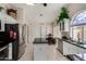 Bright kitchen featuring stainless steel appliances, dark countertops, and a white island at 18854 N 73Rd Dr, Glendale, AZ 85308