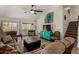 Cozy living room boasts wood-look tile, staircase, and a stylish turquoise credenza at 18854 N 73Rd Dr, Glendale, AZ 85308