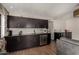 Contemporary bar area boasts sleek cabinetry, granite countertops, and a built-in beverage fridge for entertaining at 18854 N 73Rd Dr, Glendale, AZ 85308