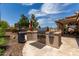 Built-in outdoor kitchen featuring a grill and ample counter space for cooking at 18854 N 73Rd Dr, Glendale, AZ 85308