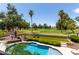 Beautiful pool and backyard with lush landscaping and golf course views at 18854 N 73Rd Dr, Glendale, AZ 85308