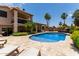 Inviting pool area with lush landscaping and a sun deck for relaxation at 18854 N 73Rd Dr, Glendale, AZ 85308