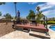 Poolside deck with comfortable seating and lush landscaping provides a tranquil space for relaxing at 18854 N 73Rd Dr, Glendale, AZ 85308