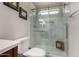 Beautiful glass shower with a shower head, a built-in bench, and light marble floors at 18854 N 73Rd Dr, Glendale, AZ 85308