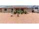 Backyard showcasing the covered patio, neat landscaping, and a low maintenance desert landscape at 1925 W 12Th Ave, Apache Junction, AZ 85120