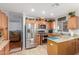 Well-lit kitchen with stainless steel appliances, wood cabinets, and granite countertops at 1925 W 12Th Ave, Apache Junction, AZ 85120