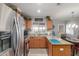 Bright kitchen with stainless steel refrigerator, wood cabinetry, and granite counters at 1925 W 12Th Ave, Apache Junction, AZ 85120