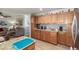 Open concept kitchen features ample wood cabinets and granite counters at 1925 W 12Th Ave, Apache Junction, AZ 85120