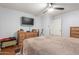 Main bedroom with ceiling fan, dark hardwood floors, neutral walls, and wood dresser at 1925 W 12Th Ave, Apache Junction, AZ 85120