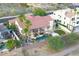 An aerial view displays the expansive backyard, pool, lush landscaping, and adjacent manicured lawns at 2053 E Clubhouse Dr, Phoenix, AZ 85048