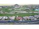 Aerial view of a neighborhood with a golf course and mountain views in the background at 2053 E Clubhouse Dr, Phoenix, AZ 85048