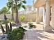 Charming backyard featuring a covered patio with elegant columns, a tiled walkway, and verdant landscaping at 2053 E Clubhouse Dr, Phoenix, AZ 85048