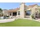 Spacious backyard with artificial grass, sparkling pool with waterfall, mature palms, and mountain views at 2053 E Clubhouse Dr, Phoenix, AZ 85048