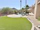 Backyard with pool, desert landscaping, and artificial turf at 2053 E Clubhouse Dr, Phoenix, AZ 85048