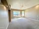 Large carpeted bedroom with a ceiling fan and scenic views from the expansive window at 2053 E Clubhouse Dr, Phoenix, AZ 85048