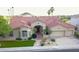 Beautiful single-story home on the golf course featuring lush desert landscaping and mature palm trees at 2053 E Clubhouse Dr, Phoenix, AZ 85048