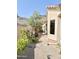 Side view of the home showcasing landscaping, fruit tree, and well-maintained yard at 2053 E Clubhouse Dr, Phoenix, AZ 85048