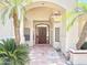 Inviting front entrance featuring a decorative arched entryway, custom wood door and red clay tile at 2053 E Clubhouse Dr, Phoenix, AZ 85048