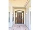 Close up of the front door framed with sidelights and topped with an arched transom window at 2053 E Clubhouse Dr, Phoenix, AZ 85048